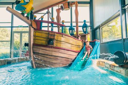 Child on the slide in the paddling pool of holiday park EuroParcs De Biesbosch