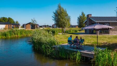 Family on a jetty at a holiday home at the EuroParcs De IJssel Eilanden holiday park