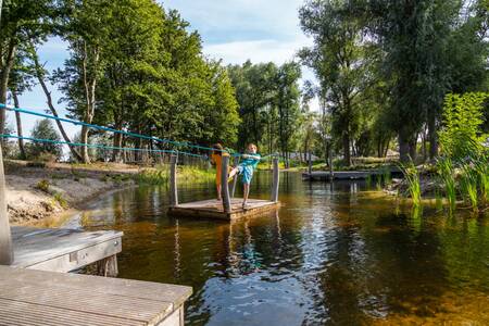 Children on a raft at holiday park EuroParcs De IJssel Eilanden