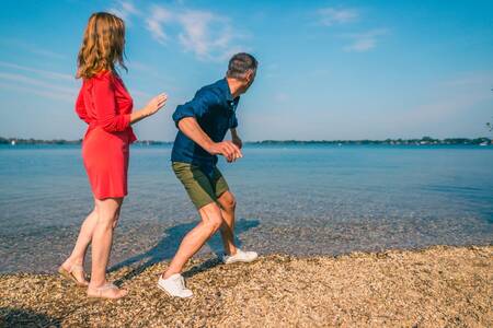 Couple on the beach at holiday park EuroParcs De Kraaijenbergse Plassen