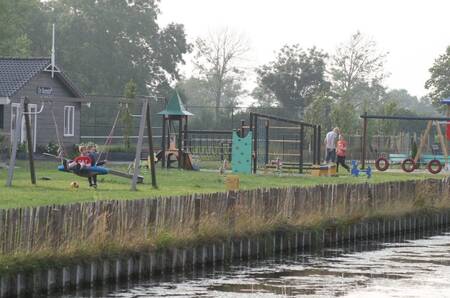 Children play in the playground at the EuroParcs De Rijp holiday park