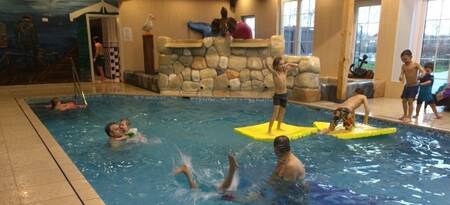 People swimming in the indoor pool at holiday park EuroParcs De Rijp