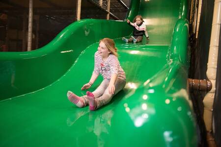 Children on the slide in the indoor playground of holiday park EuroParcs De Wije Werelt
