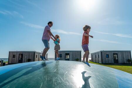 People jump on the air trampoline in a playground at the EuroParcs Enkhuizer Strand holiday park