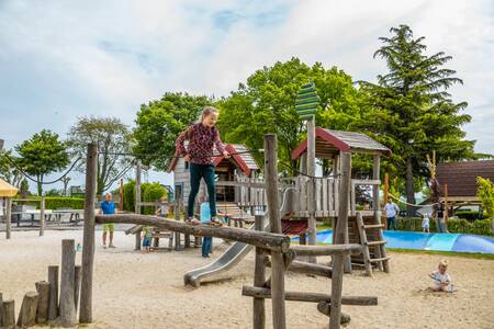 Children play in the large playground of holiday park EuroParcs Gulperberg