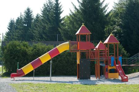 Playground equipment with a slide in a playground at the EuroParcs Hermagor Nassfeld holiday park