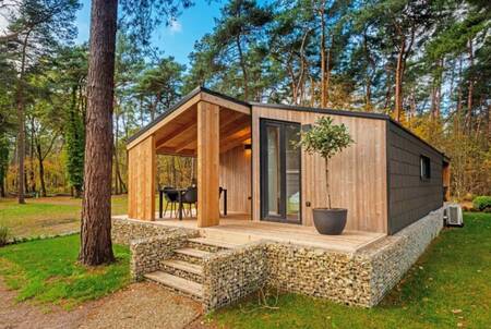 Detached chalet with garden furniture under a roof at the EuroParcs Hoge Kempen holiday park