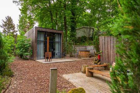 Garden with brazier of a Tiny House at the EuroParcs Maasduinen holiday park