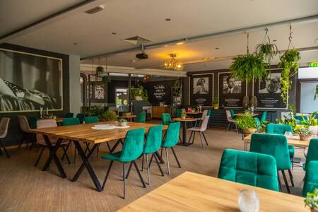 Tables with chairs in the atmospheric restaurant at the EuroParcs Maasduinen holiday park