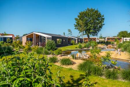 Chalets along a ditch at the EuroParcs Marina Strandbad holiday park