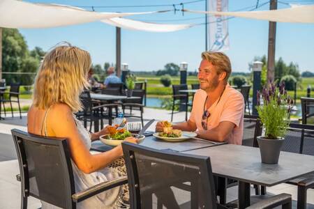 Couple on the terrace of the restaurant at holiday park EuroParcs Marina Strandbad