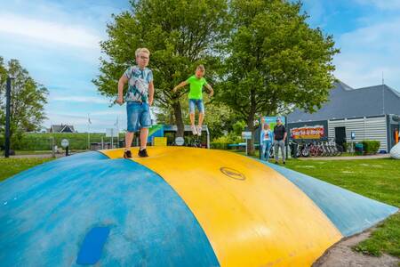 Children jump on the air trampoline at the EuroParcs Markermeer holiday park