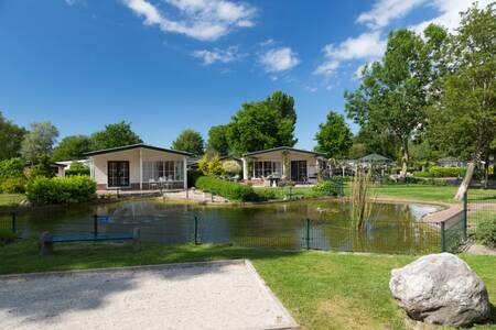 Chalets on a pond at the EuroParcs Molengroet holiday park