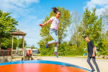 Children jump on the air trampoline in the playground at the EuroParcs Molengroet holiday park