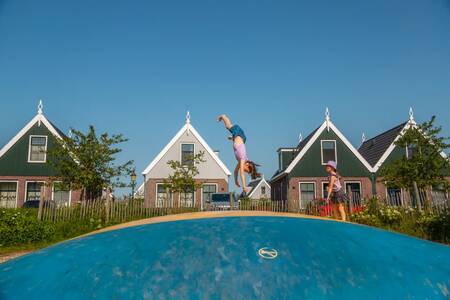 Children jump on the air trampoline in a playground at EuroParcs Poort van Amsterdam