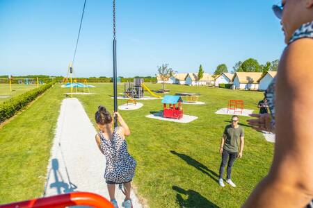 Children on a cable car in a playground at the EuroParcs Poort van Maastricht holiday park