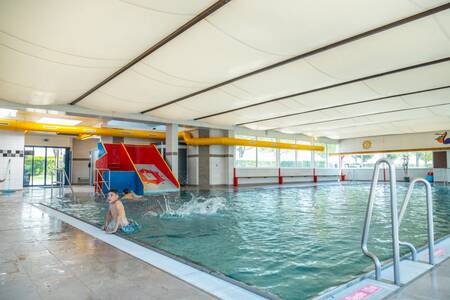 Children swimming in the swimming pool of holiday park EuroParcs Poort van Maastricht
