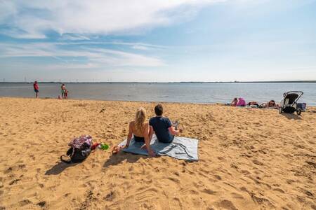 People on the beach near the EuroParcs Poort van Zeeland holiday park