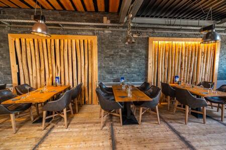 Tables and chairs in the restaurant at the EuroParcs Poort van Zeeland holiday park