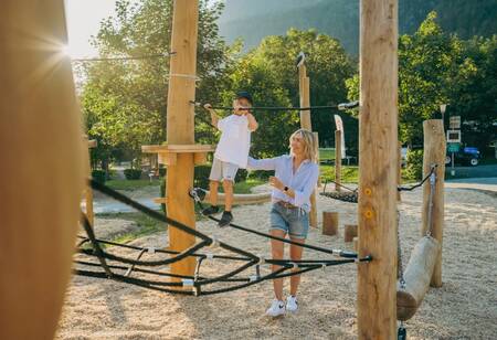 Boy climbing in the playground of the EuroParcs Pressegger See holiday park