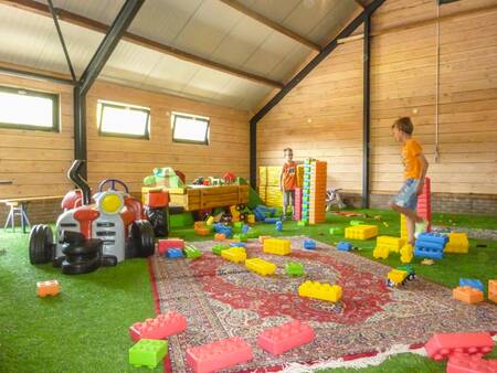 Children play in the indoor playground of holiday park EuroParcs Ruinen
