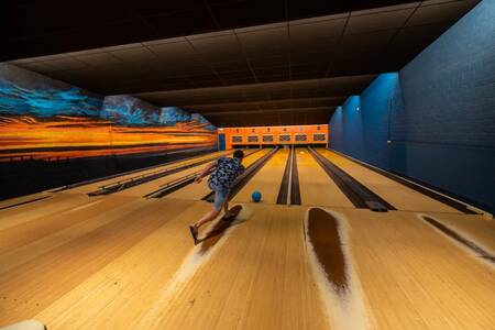 Man bowling on the bowling alley of the EuroParcs Schoneveld holiday park