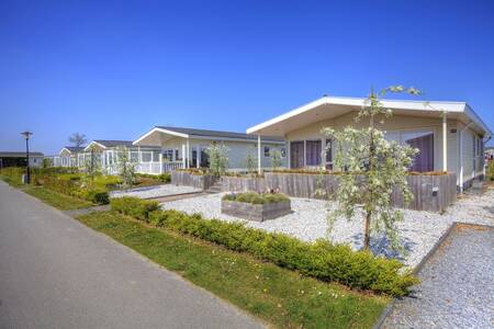 Chalets along an avenue at the EuroParcs Schoneveld holiday park