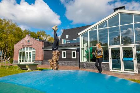 Children jump on the air trampoline in the playground at the EuroParcs Spaarnwoude holiday park