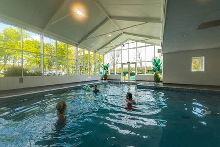 People swimming in the indoor pool of the EuroParcs Spaarnwoude holiday park