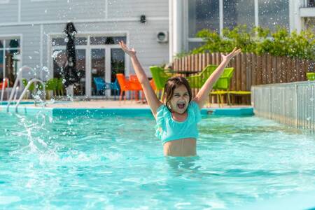 Girl swimming in the swimming pool of the EuroParcs Veluwemeer holiday park