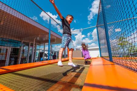 Children jump on the trampoline at the EuroParcs Veluwemeer holiday park