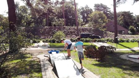 People play golf on the miniature golf course of holiday park Europarcs EuroParcs Zilverstrand