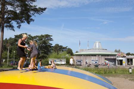 Children jump on the air trampoline in the playground at the Europarcs EuroParcs Zilverstrand
