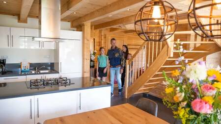 People in the kitchen of a holiday home at the Europarcs de Achterhoek holiday park