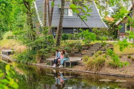 Family on a jetty at a holiday home at the EuroParcs de Zanding holiday park