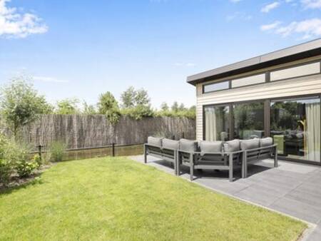 Lounge set in the garden of a holiday home at the Familiehuis Nunspeet holiday park