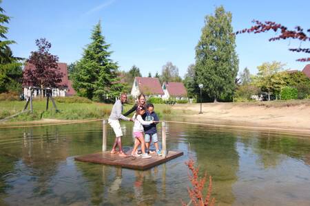 Family on a raft on a pond in the Hellendoorn holiday park