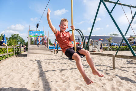 Boy on a cable car in a playground at the Hellendoorn holiday park