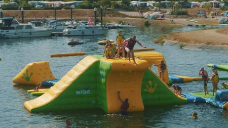 Children play on inflatable devices in the aqua park in the marina of the Leukermeer holiday park