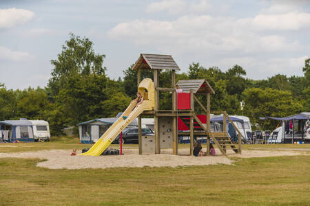 Children play in a playground on a camping field at holiday park Wilsumer Berge