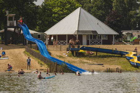 People slide down the slides that end up in the lake at holiday park Wilsumer Berge