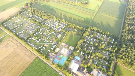 Aerial view of holiday park 't Rheezerwold between the meadows in Overijssel