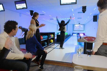 People bowling on the bowling alley of holiday park Mölke