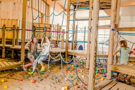 Children playing in the indoor playground of holiday park Mölke