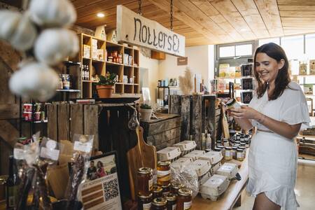 Woman shopping in the local shop of holiday park Mölke