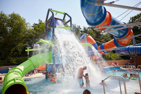 Outdoor pool with slides at camping village de Zandstuve