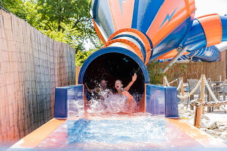 Slide outside in the subtropical swimming pool of holiday park Kampeerdorp de Zandstuve