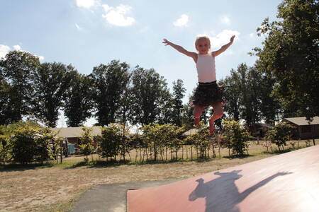 Girl playing on an air trampoline at Krieghuusbelten holiday park