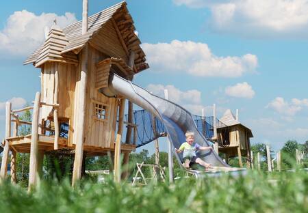 Child on a slide in a playground at Krieghuusbelten holiday park