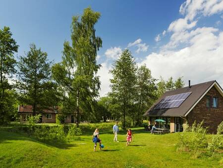 Children play in the garden of a holiday home at Landal Aelderholt holiday park